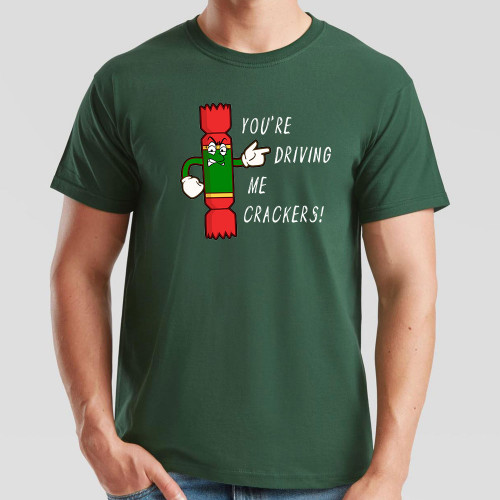 Dark Green T-Shirt printed with text You’re Driving Me Crackers and a cartoon anthropomorphised Christmas cracker pointing to the wearer’s left.